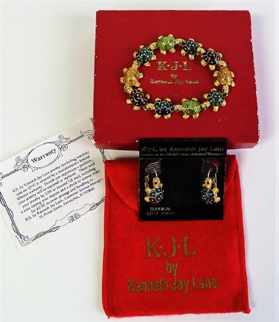 KJL BY KENNETH J. LANE ENAMELED TURTLE SUITE: This lot includes a signed KJL gold tone and multi-coloured enameled turtle bracelet with matching clip earrings. Includes original box and packaging. Shipping to be $15 US. We will combine with price