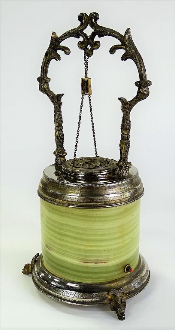 REUGE CIGARETTE HOLDER AND MUSIC BOX: Reuge cigarette holder and music box, the body is of green onyx and silver footed base, to top is a silver frame and handle with a pulley system that opens the door to the cigarette holder, plays beau