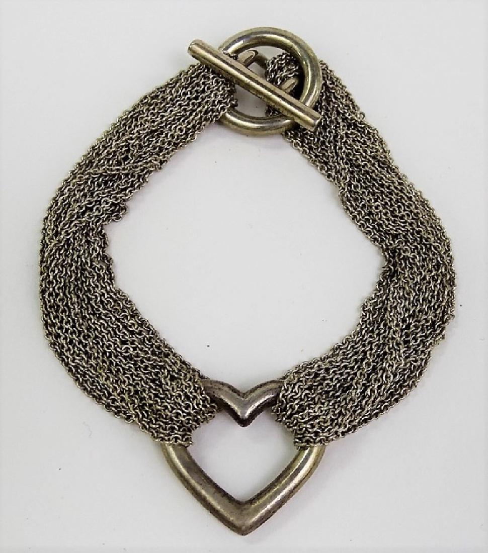 TIFFANY & CO STERLING MULTI CHAINED HEART BRACELET: About 7" long, total weight 36 grams, shipping $20 plus ins u.s.