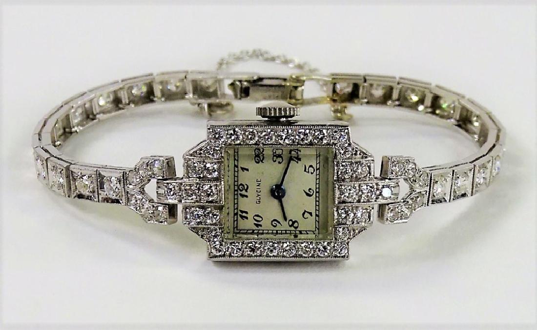GLYCINE DECO PLATINUM 1.75CT DIAMOND WATCH: Ladies' Glycine Swiss antique deco Platinum watch set with approx. 1.75cts. of round brilliant cut Diamonds. Has a silvered dial with Arabic numerals. Weighs approx. 11.2 dwt (17.5 grams). Shipping to