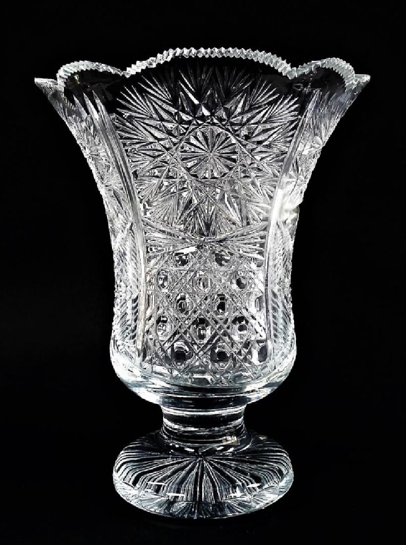 ANTIQUE BRILLIANT CLEAR CUT CRYSTAL FOOTED VASE: Large antique brilliant cut crystal footed vase, having flared shape and saw tooth cut rim. In clear color, with hobnail and star cut patterns. Unsigned. Measures approx. 12" H. Referred shippers avai