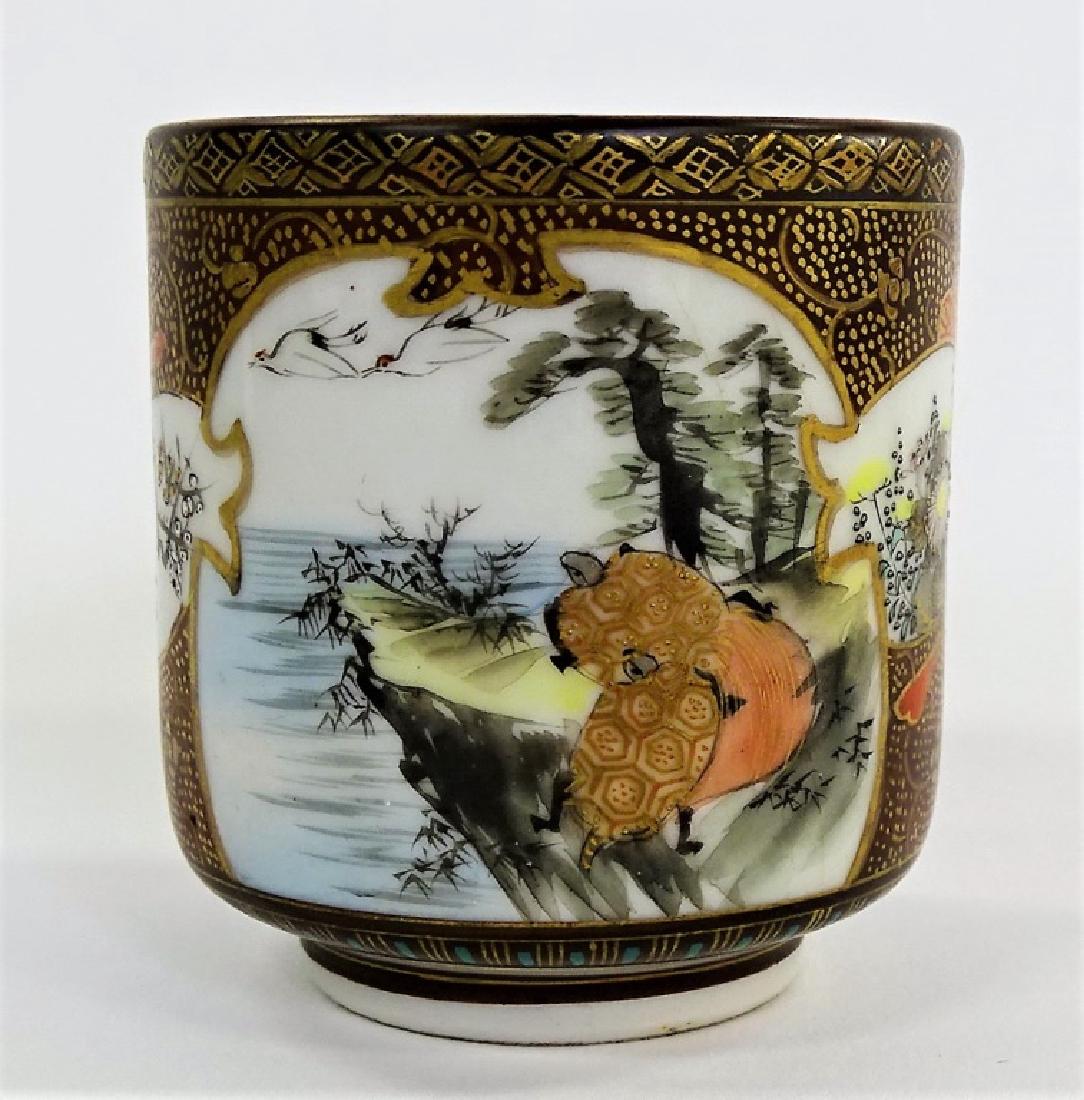 ANTIQUE JAPANESE SATSUMA PORCELAIN WEDDING CUP: Antique Japanese Satsuma hand painted porcelain wedding cup depicting landscape and wise man scenes to exterior. Black calligraphy poem to interior. Calligraphy marks to bottom. Circa late Edo to Meij