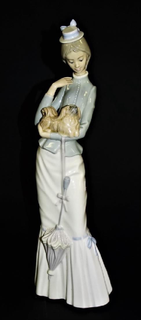 LLADRO PORCELAIN "WALK WITH THE DOG" #4893 FIGURE: Lladro Spain porcelain 'Walk with the Dog' figure, #4893. Issued in 1974, retired in 2004. Sculpted by Jose Roig. Has a glazed finish. Measures approx. 14-5/8"H. Will not ship, we can refer local ship