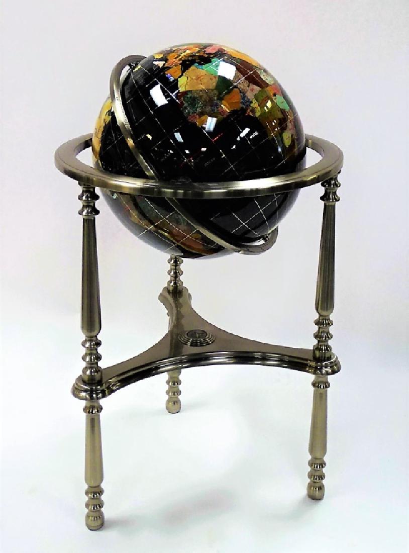 CONTEMPORARY DECORATIVE STONE INLAID GLOBE: Contemporary style decorative inlaid stone globe with stand. The globe section having a black enameled ground inlaid with a variety of semi-precious stone country markers, to include: Mother of Pearl,