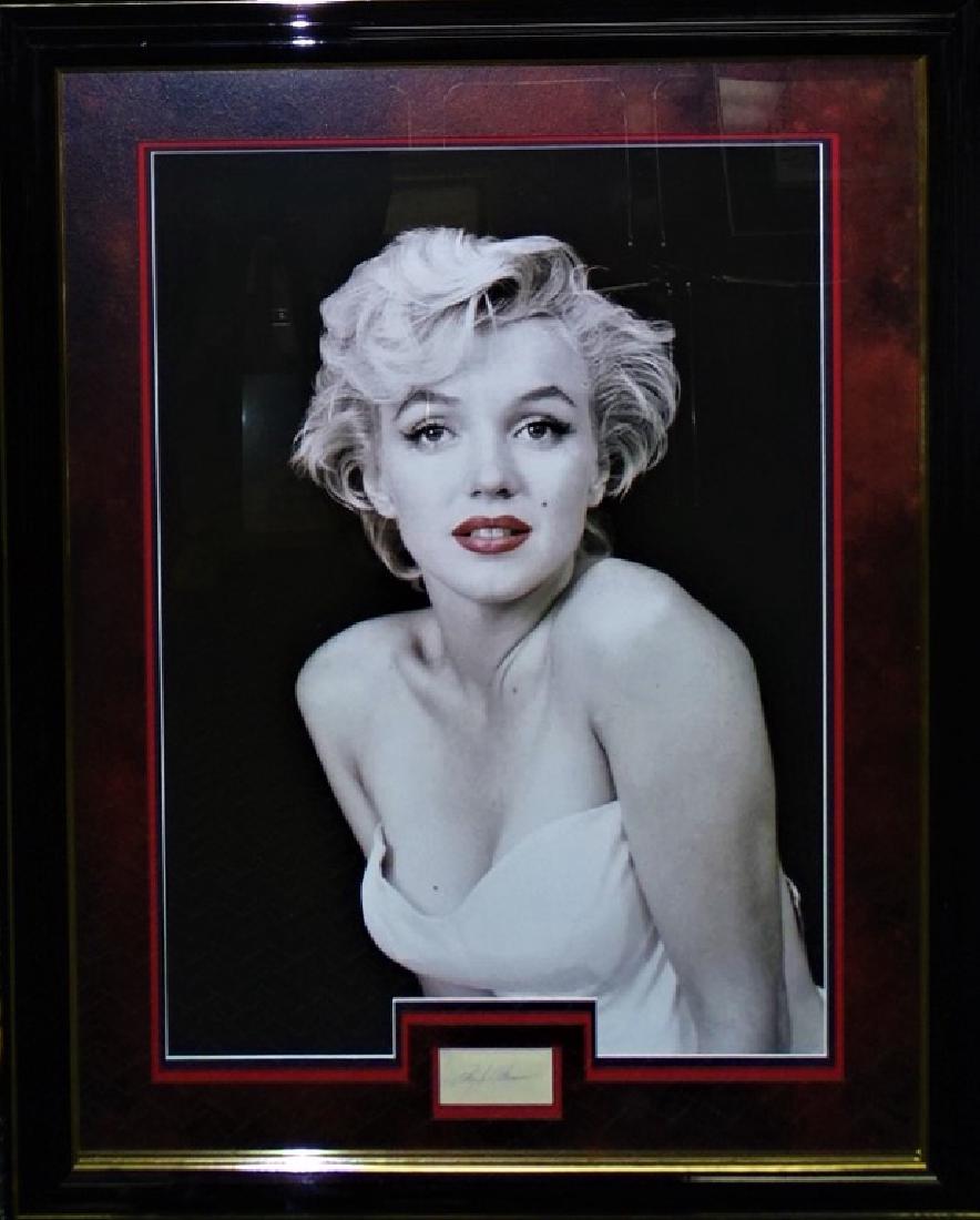 AUTHENTIC FRAMED MARILYN MONROE SIGNATURE DISPLAY: Rare, one of a kind framed entertainment memorabilia piece featuring the signature of famous American actress and model Marilyn Monroe. Framed together with large photograph print. Accompanied by JSA