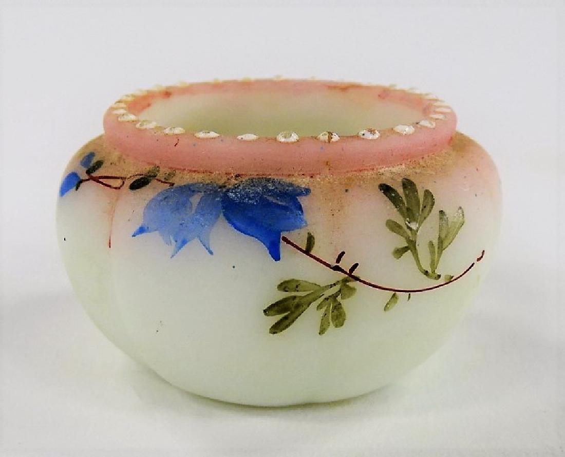 19TH CENTURY MT. WASHINGTON SALT CELLAR: Late 19th century Mt. Washington lusterless satin glass salt cellar, in ribbed form. Hand-painted with delicate enamel floral decorations. Many types of art glass were made by Mt. Washington until 189