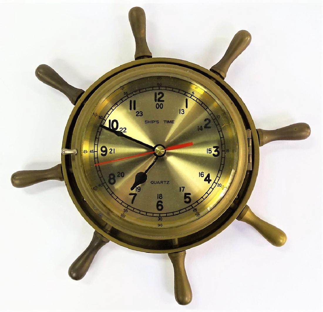 VINTAGE SHIP'S TIME BRASS WALL CLOCK: Vintage brass wall clock in the form of a ship's mast. Having a brushed metal dial with Arabic numerals. Fit with a quartz movement. Measures approx. 12-1/2" in diameter. Referred shippers available u