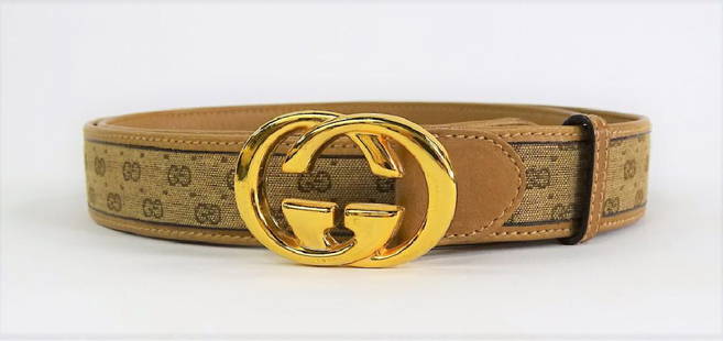 VTG GUCCI LEATHER & CANVAS BELT W/ MONOGRAM BELT: Vintage Gucci monogram canvas belt with tan leather trim and goldtone metal monogram buckle. Buckle marked "Gucci - Italy, Mod. Brev." Belt size 38. Referred shippers available upon request.