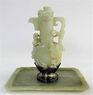 RARE EDWARD FARMER STERLING & CHINESE JADE PITCHER: An Edward I. Farmer sterling silver mounted Chinese mutton fat jade lidded pitcher. The silver made circa 1920, the jade earlier, possibly Qianlong period (1736 - 1795). Having the cloud work sterling