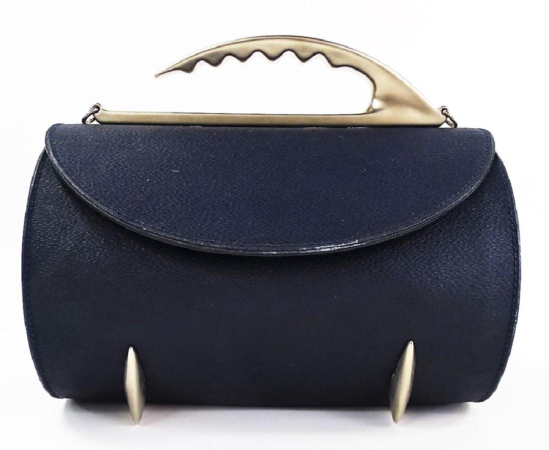 IVAN CIPRIANI ITALIAN MADE NAVY LEATHER BARREL BAG: Features magnetic clasp, shoulder strap and single zipper pocket to interior. Measures 8" L x 5" W x 5" T + 1-3/4" Handle. Third Party Shipping Required. Local Recommendations Are Available.
