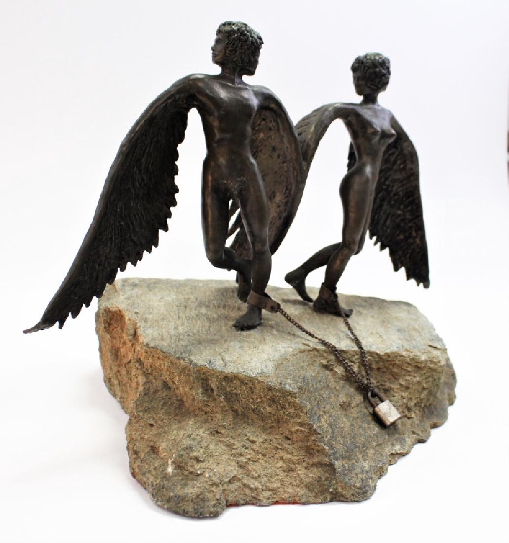 PATINATED BRONZE SCULPTURE OF MALE & FEMALE ANGEL: Antique patinated bronze sculpture modeled in the form of a male and female angel shackled together at the ankle and standing atop a natural boulder base. Measures approx. 12-1/4"H x 15"W x 11"D. Thir