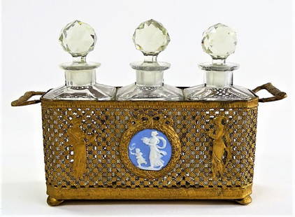 ANTIQUE GERMAN BRASS TRIPLE BOTTLE PERFUME CADDY: Antique German crafted brass perfume caddy, in ornate floral lattice work design, mounted with one circular Wedgwood porcelain jasperware plaque. Contains three square form bottles, each with a