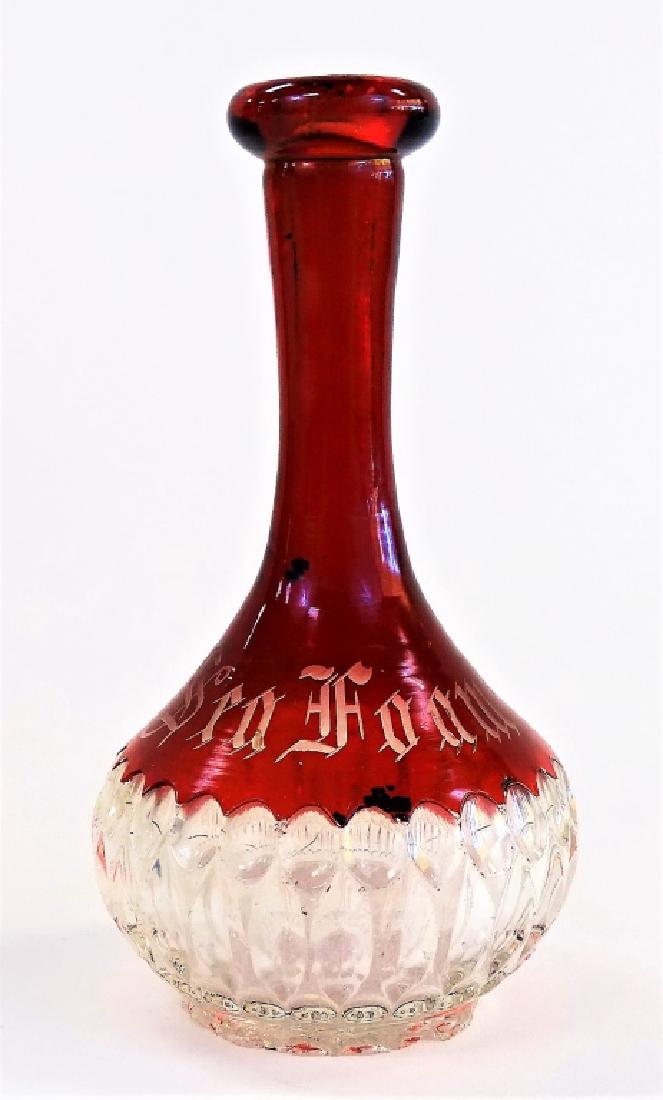ANTIQUE CUT GLASS SEA FOAM BARBERS BOTTLE: Antique cut glass barber's bottle in ruby cut to clear color, etched "Sea Foam" label to obverse. Stands approx. 7"H. Third party shipping required. Local recommendations available. Please note: Botto