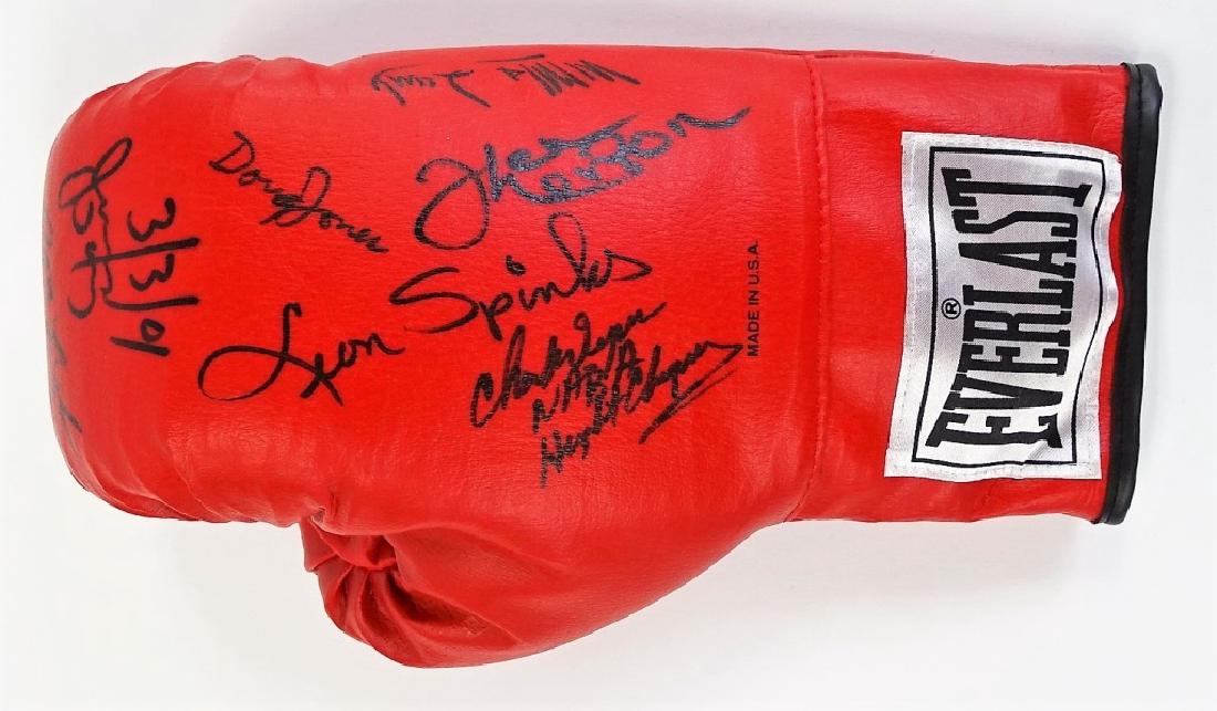 PRO BOXING MEMORABILIA AUTOGRAPHED LEGENDS GLOVE: Authentic sport's memobilia piece featuring a 12oz Everlast Pro-Boxing glove signed throughout in black Sharpie with signatures to include; Leon Spinks, Doug Jones, Earnie Shavers, plus more. Measures