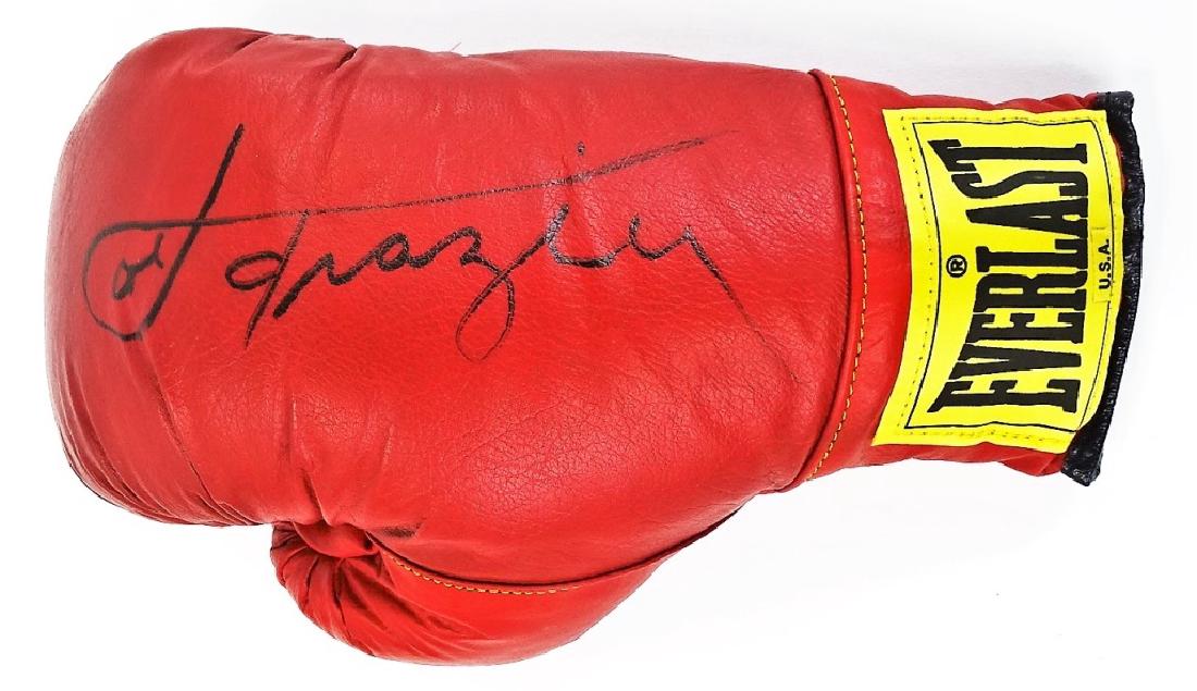 PRO BOXING MEMORABILIA JOE FRAZIER SIGNED GLOVE: Authentic sport's memorabilia piece featuring a 14oz Everlast Pro-Boxing glove signed in black Sharpie by Smokin' Joe Frazier. Measures approx. 12-3/4"L. Third party shipping required. Local recommend