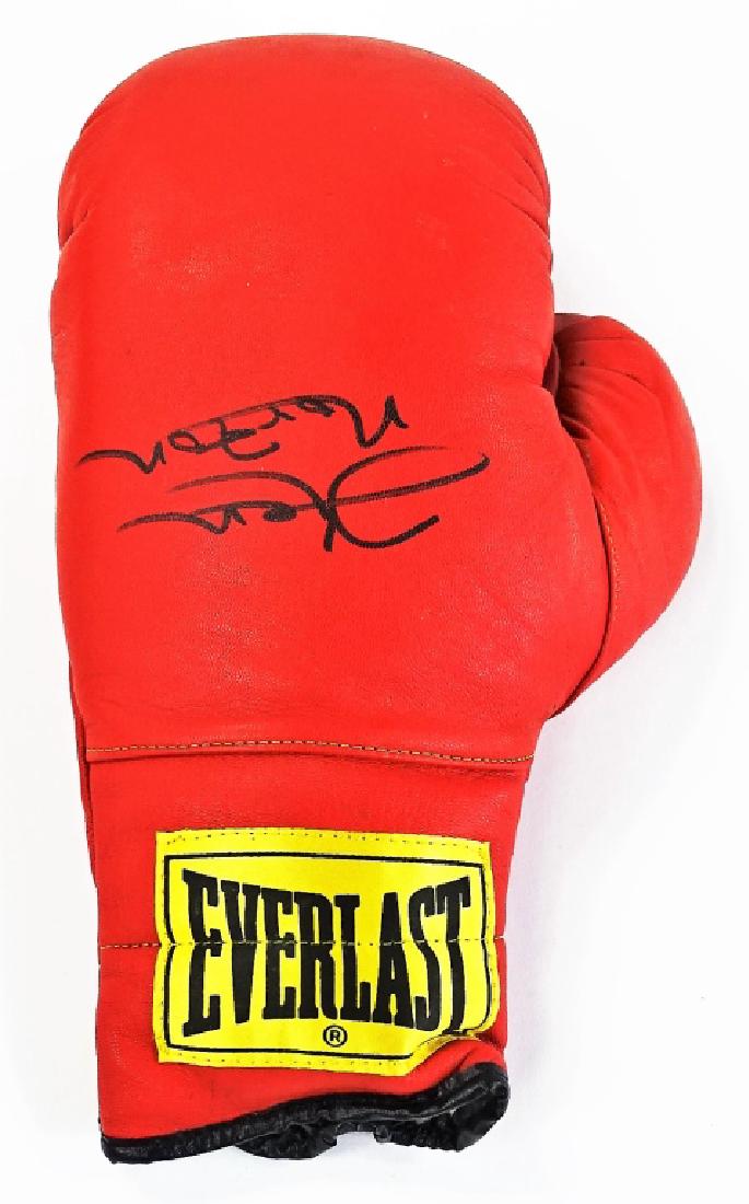 PRO BOXING MEMORABILIA KEN NORTON SIGNED GLOVE: Authentic sport's memorabilia piece featuring a 16oz Everlast Pro-Boxing glove signed in black Sharpie by Kenneth Howard Norton Sr. Measures approx. 13-3/4"L. Third party shipping required. Local reco
