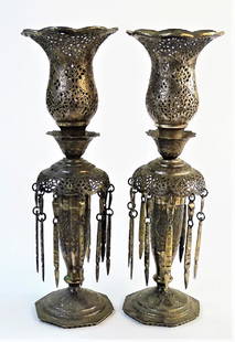 PR ANTIQUE PERSIAN RETICULATED SILVER CANDLESTICKS: Pair of tall antique Persian silver candlesticks, with reticulated and flared form candle cups having scalloped rims. Mounted on a reticulated bonnet with dangling ornaments, rising on a knopped