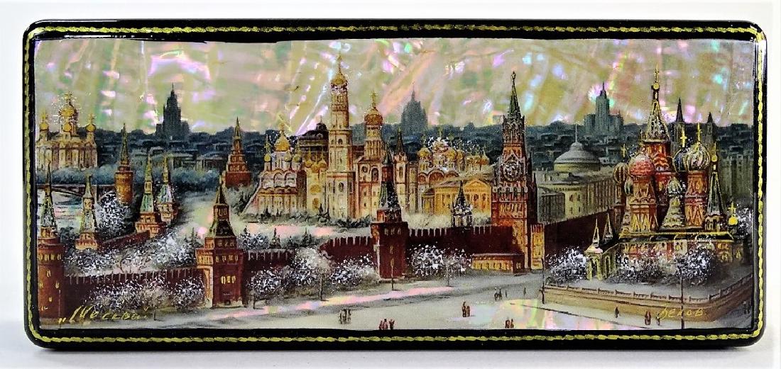 HAND PAINTED MOTHER OF PEARL RUSSIAN LACQUER BOX: Fine Russian lacquer casket box, in rectangular shape, with winter town scene hand-painted over a Mother of Pearl surface. Artist signed in cyrillic. Measures approx. 1-3/8"H x 5-5/8"L x 2-1/2"W. Thir