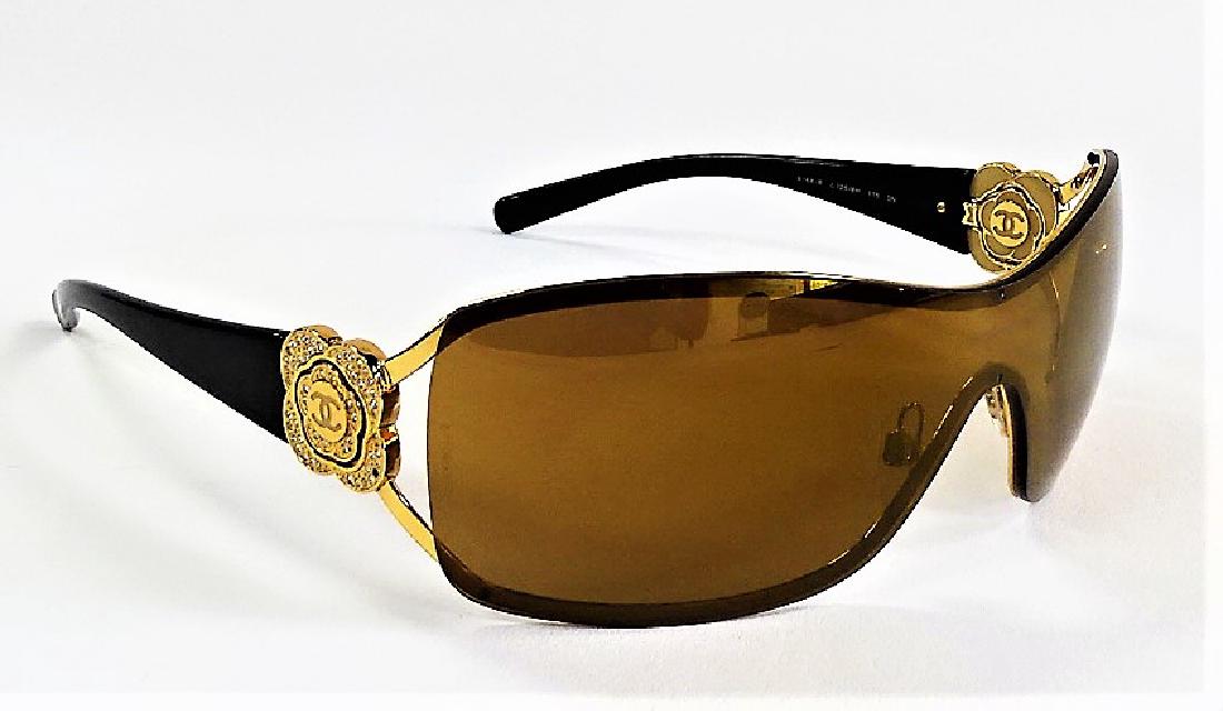 CHANEL CAMELLIA FLOWER CRYSTAL SUNGLASSES w/ CASE: Chanel black & gold monogram Camellia Swarovski crystal sunglasses. Comes with Chanel sunglass case. Made in Italy. From a Boca Raton estate. Shipping $20 plus insurance.
