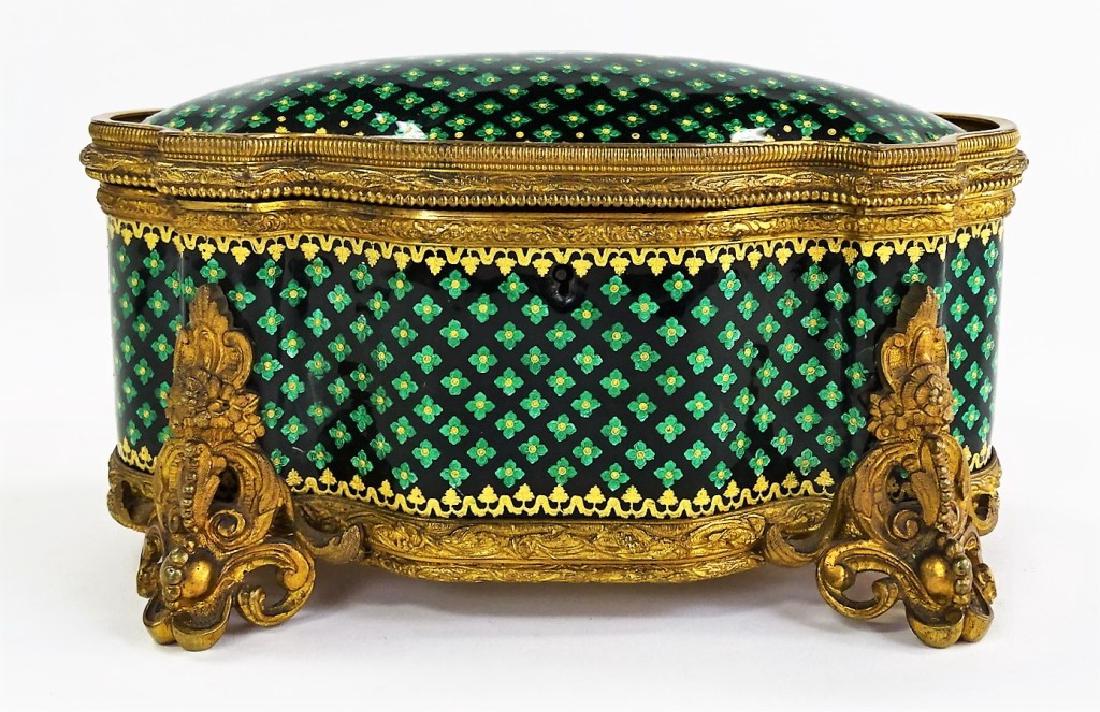 ANTIQUE FRENCH ENAMELED BRASS DRESSER BOX: Antique French brass dresser box, of hinged design. Having inset panels decorated wwith hand-laid enamels in black, green, and gold. with fabric lined interior. Measures approx. 4-1/2"H x 8"L x 5"W. T