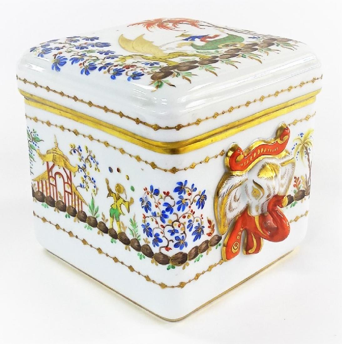TIFFANY SEVRES STYLE ORIENTALIST PORCELAIN BOX: Covered box bears French marks to base, dates to the mid 20th century. Measures 5 1/2" , And wide. Square in shape with elephant handles . Depiction is of a man riding a Dragon . This box was distribu
