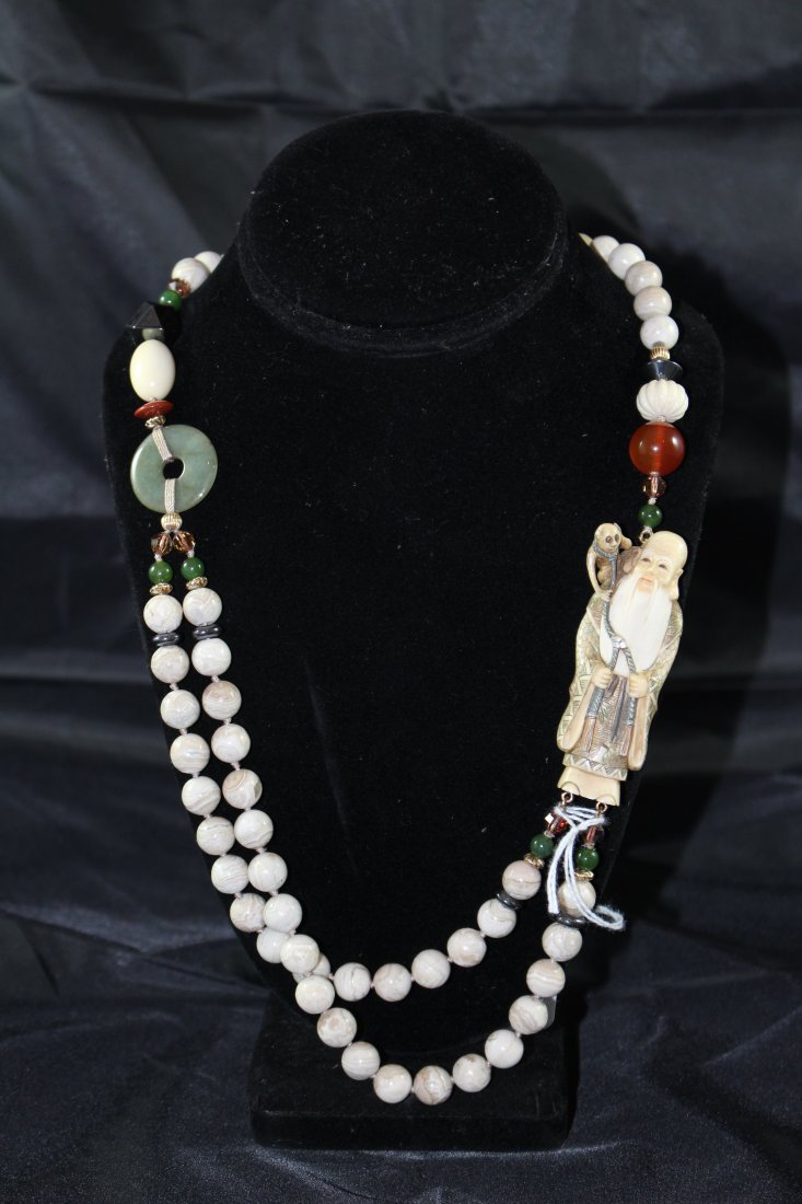 CHINESE ANTIQUE IVORY NETSUKE AND GEMSTONE NECKLACE: 24 " long, large carved ivory elder with monkey. has beads of ivory, carnelian, and jade. dates to the early 20th century we do NOT condone the sale of endangered animals, this item was imported legal