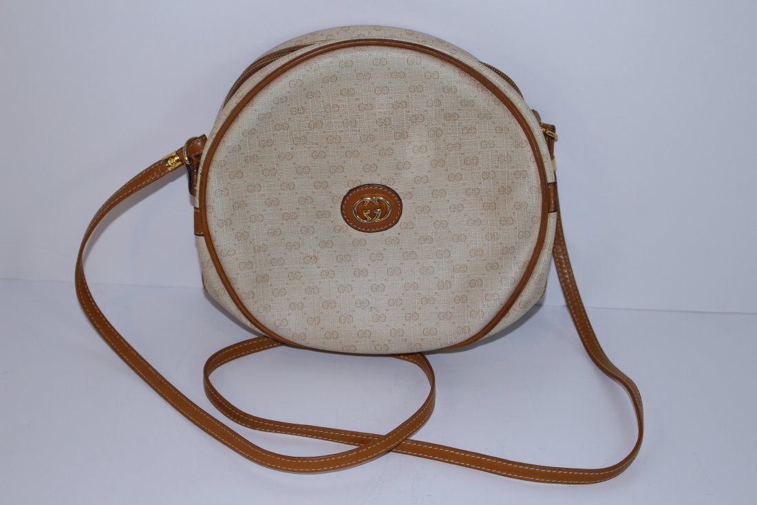 GUCCI LEATHER AND CANVAS COLOR LEATHER ROUND BAG: From a prominent Palm Beach estate, measures 8" across,TAN leather, shipping U.S. $35 plus ins