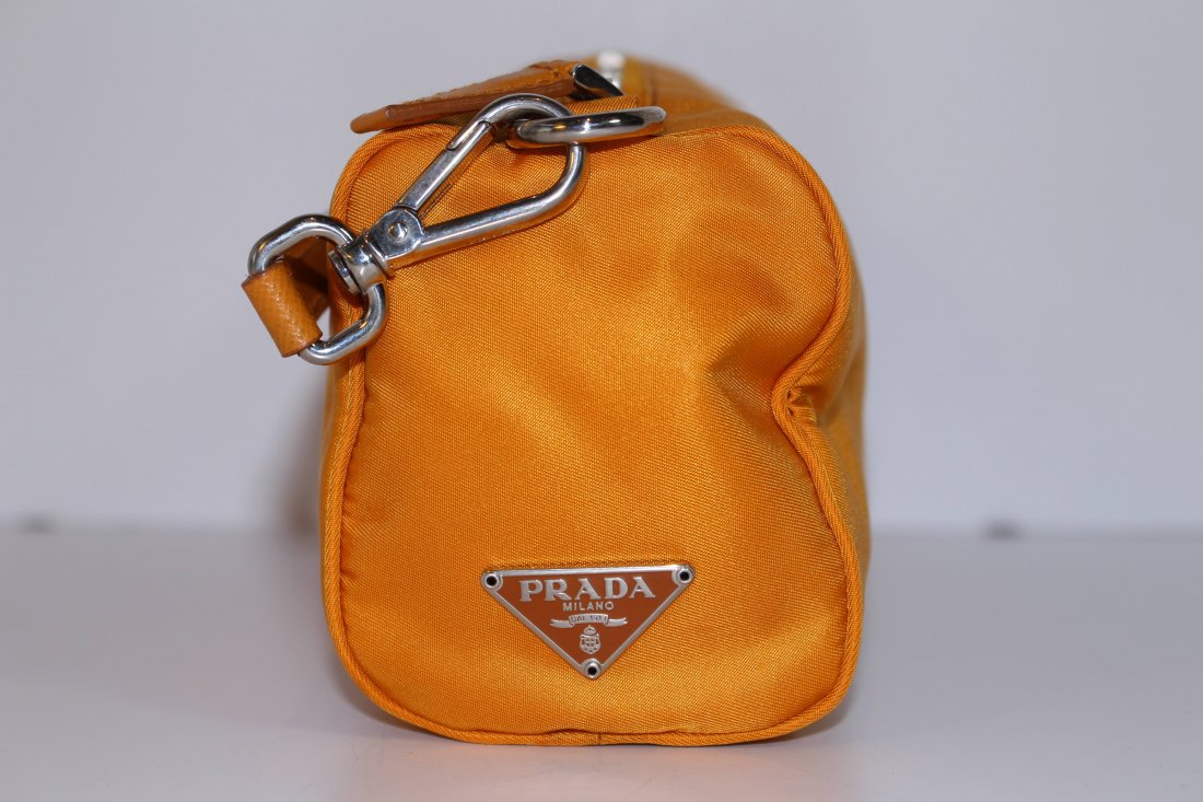 PRADA CANVAS ORANGE COLOR BAG: From a prominent Palm Beach estate, measures 8\" acrosS shipping U.S. $35 plus ins