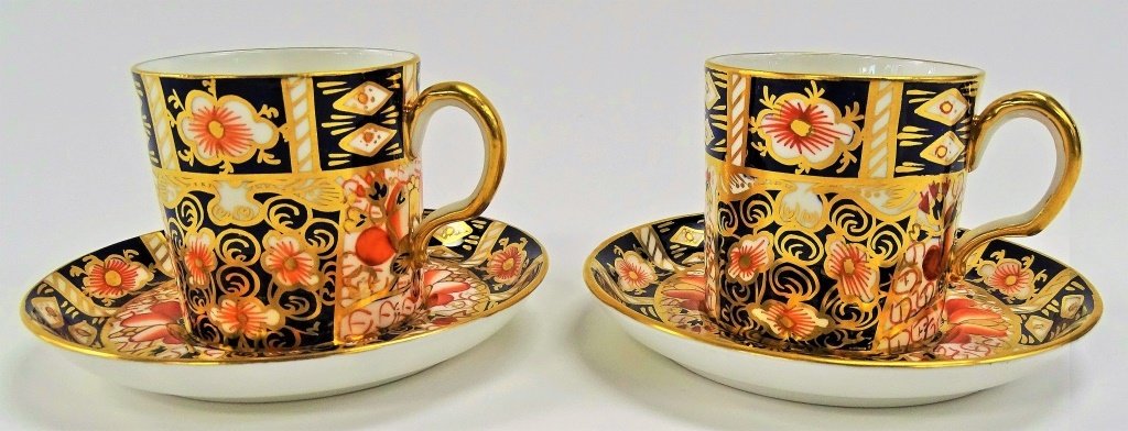 PAIR OF ROYAL CROWN DERBY BONE CHINA CUP & SAUCER: Made in England. Stamped to base. Cup measures 2 1/2" tall. Saucer measures 4 1/2" diameter. Will refer local shippers.