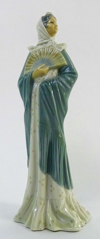LLADRO NAO PORCELAIN FIGURE OF WOMAN WITH FAN: LLADRO NAO; Porcelain figure of woman in piano shawl holding a fan. High gloss finish. Marked on bottom NAO, Made in Spain. Stands approx. 12" high. Will not ship, we can refer local shippers.
