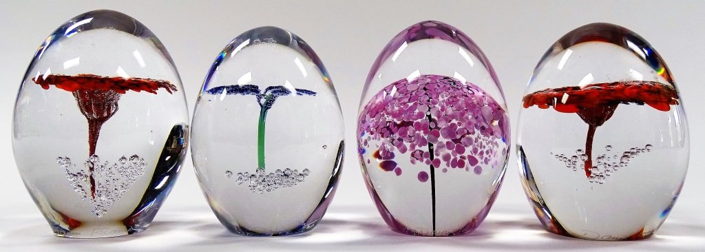 4 DAUM FRANCE ART GLASS PAPERWEIGHTS: Lot of 4 Daum French art glass paperweights, controlled interior designed with flowers. Each has etched Daum France signature near base. Tallest measures approx. 3 1/4" high.