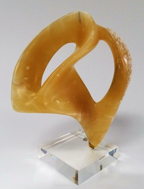ANNE HARRIS FREE FORM ALABASTER SCULPTURE: Harris, Anne (Canadian, 20th); Beautifully carved Alabaster sculpture in free form, light Honey color. Affixed to square lucite base. Unsigned. Measures approx. 9 3/4" H x 7 3/4" W x 4" D. Will not sh