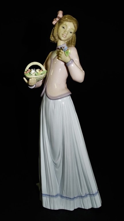 LLADRO PORCELAIN 'INNOCENCE IN BLOOM' FIGURE #7644: Lladro Spanish porcelain 'Innocence in Bloom' figure #7644, issued and retired in 1996. Part of the Lladro Society collection. Sculpted by Jose Puche. Has glazed finish. Includes original box. Measure