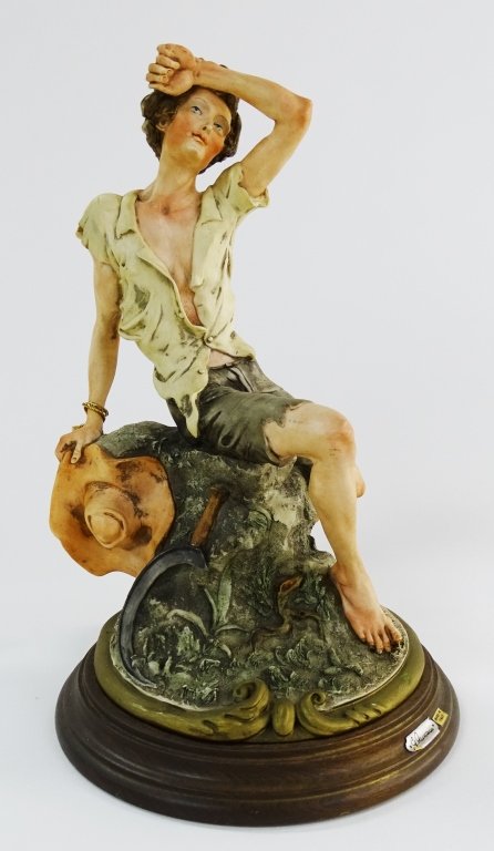 GIUSEPPE ARMANI FIGURINE OF A GUY WOKRING: Giuseppe Armani figurine of a man taking a break from a days work. Measures approx 13" tall. Will not ship can refer local shippers.