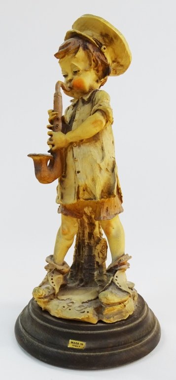GUISEPPE ARAMNI FIGRUINE BOY WITH SAXOPHONE: Guiseppe Armani Figurine Boy with Saxophone #3489. Measures approx 10 ' tall. Will not ship can refer local shippers.