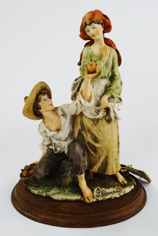 GUISEPPE ARMANI FIGURINE MAN GIVING APPLE TO GIRL: Guiseppe Armani figurine of a man giving a apple to a girl. Measures approx 11' tall. Will not ship can refer local shippers.