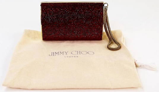 JIMMY CHOO DESIGNER RED GLITTER CLUTCH HANDBAG: Jimmy Choo designer Italian crafted clutch purse. Done with goldtone framework and hardware. Jeweled throughout with red colored crystals. Open to fabric lined interior. Bag measures approx. 5-7/8"W