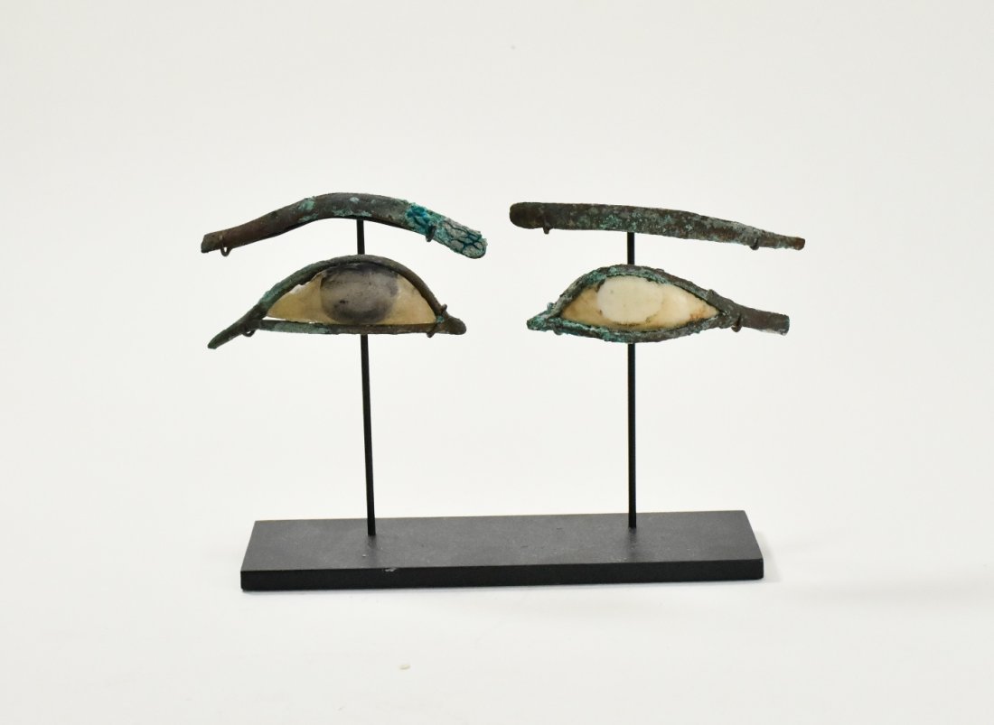 A Pair of Egyptian Bronze & Calcite Egyptian Eye Inlays: Length: 3 1/4 inch (each) (8 cm.) 664-332 B.C. / Late Period Ex. Maryland private collection, acquired in 1973. The slender curved eye rims with extended cosmetic lines, with white stone sclera and bl