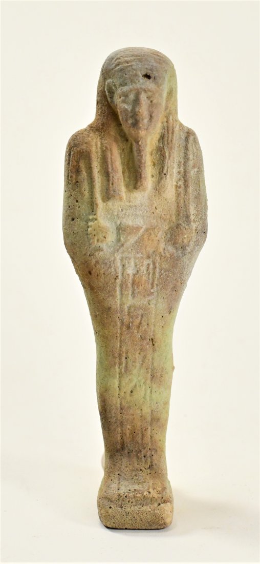 An Egyptian Faience Ushabti: Height: 4 1/2 inches (11.4 cm.) 700-30 B.C. Ex. Florida private collection, K.S., 1975. Authenticity guaranteed. A certificate + official Aphrodite Gallery authenticity hang-tag will be issued to the