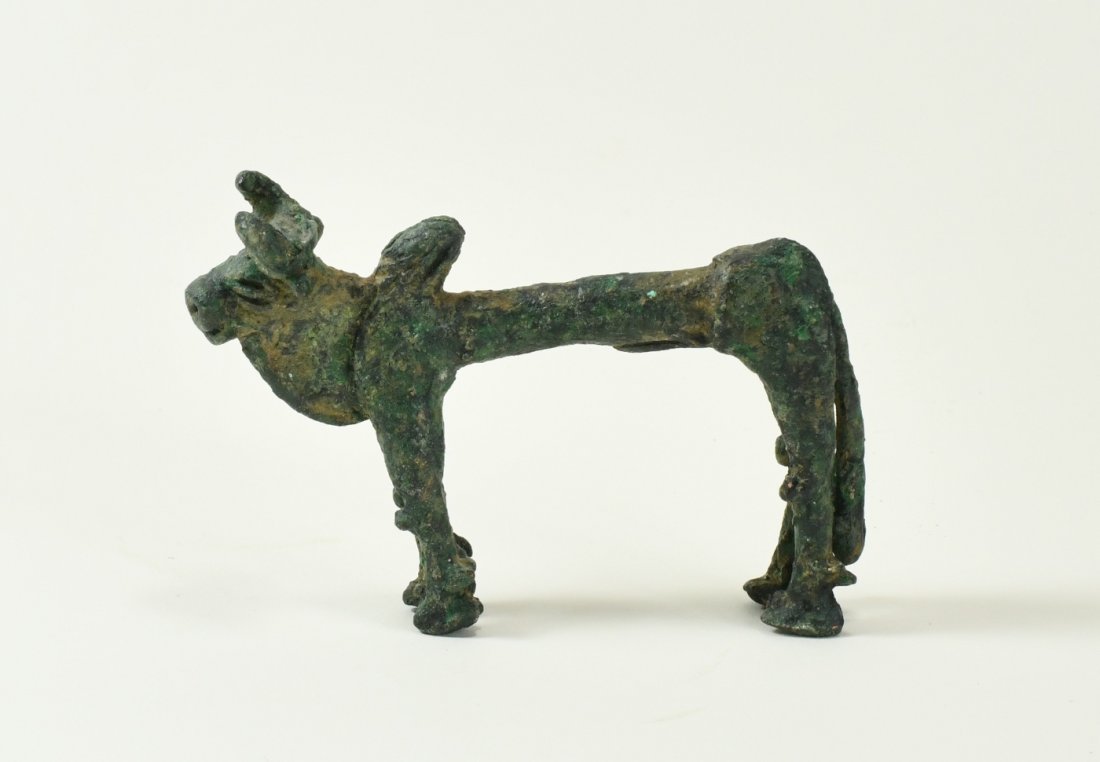 A Canaanite Figure of a Humped Bull: Standing on a solid pose with a pronounced dewlap, circular snout with grooved mouth, indented nostrils and large protruding eyes, his long erect phallus (denoting fertility), attached underneath his