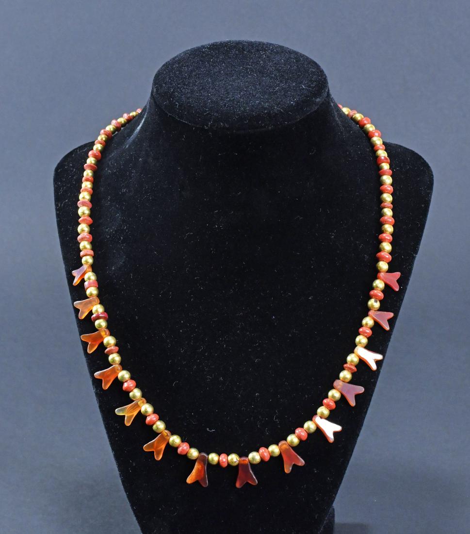Egyptian Carnelian and Gold Beads Necklace: Consisting of 14 fly amulets in Carnelian and red jasper, re-strung, in between alternating ancient Carnelian and modern gold beads. Cf. A parallel necklace sold at Christie's Jewelry in 2012, lot 354