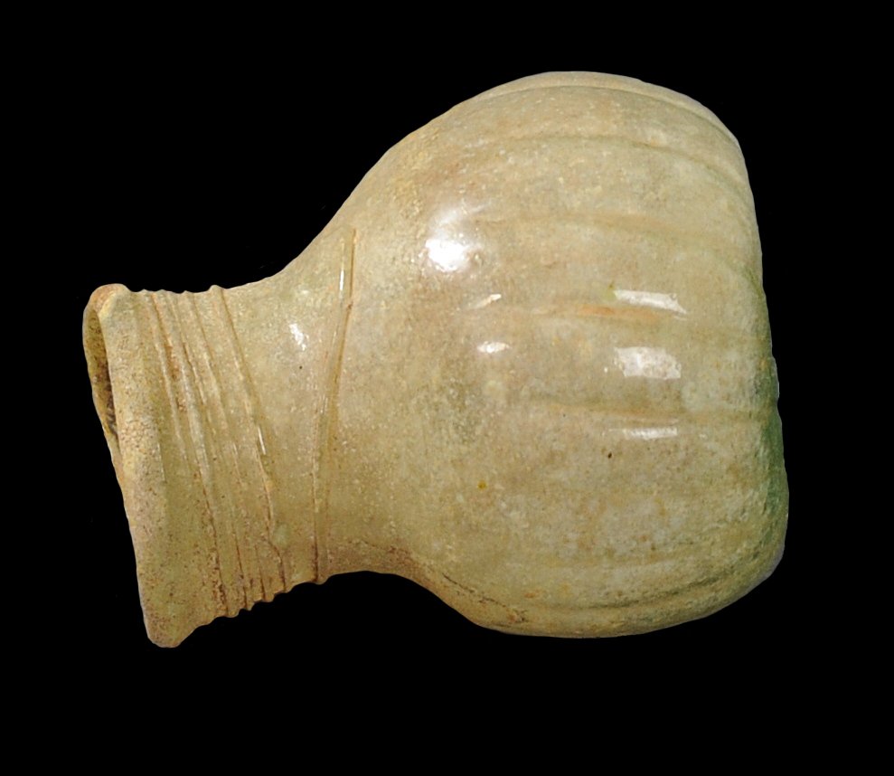 ANCIENT ROMAN SPIN STYLE GLASS FLASK: Features an indented inwards bottom. Vertical ribs on the body. Has a particularly unique circular opening, with lines in a spin-type motif circling the top part. Circa 2nd-3rd Century A.D.Measurement