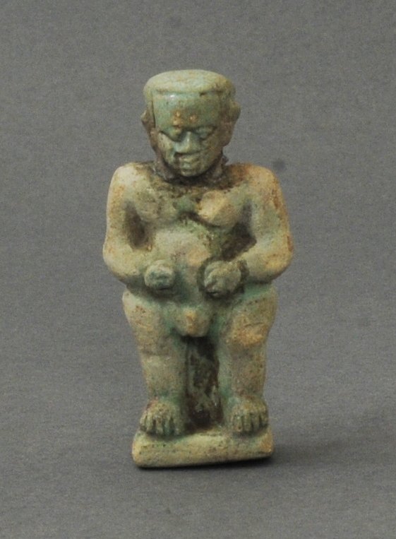 ANCIENT EGYPTIAN FAIENCE FIGURE OF PATAEK: Representing a Pataek god of protection. Standing, traces of original green glazing still preserved. Circa 26th-30th Dynasty (664-332 B.C.) Measurements: 2 1/2 in. H. (6 cm.) Ex: Important German priv