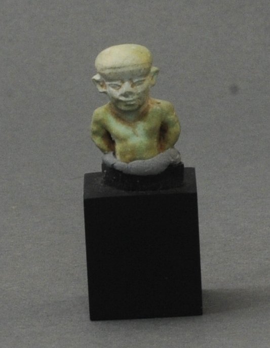 ANCIENT EGYPTIAN FAIENCE FRAGMENTARY AMULET OF PATAEK: Circa 664-332 B.C. Measurements: 3/4 in. H. (2.4 cm.) Ex: Important German private collection of Egyptian works; Ex: German art market. Reference No. AGA2-118. Authenticity guaranteed. A certificate w