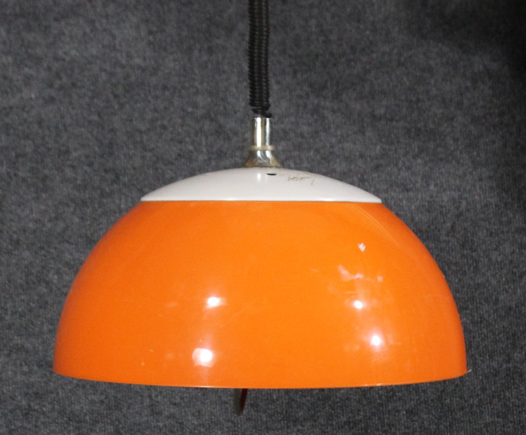 MID CENTURY MODERN ORANGE AND WHITE PLASTIC DOME LAMP: MID CENTURY MODERN ORANGE AND WHITE PLASTIC DOME LAMP.Hanging fixture. Very good condition.Size: 8 h , 16 diameter , inches