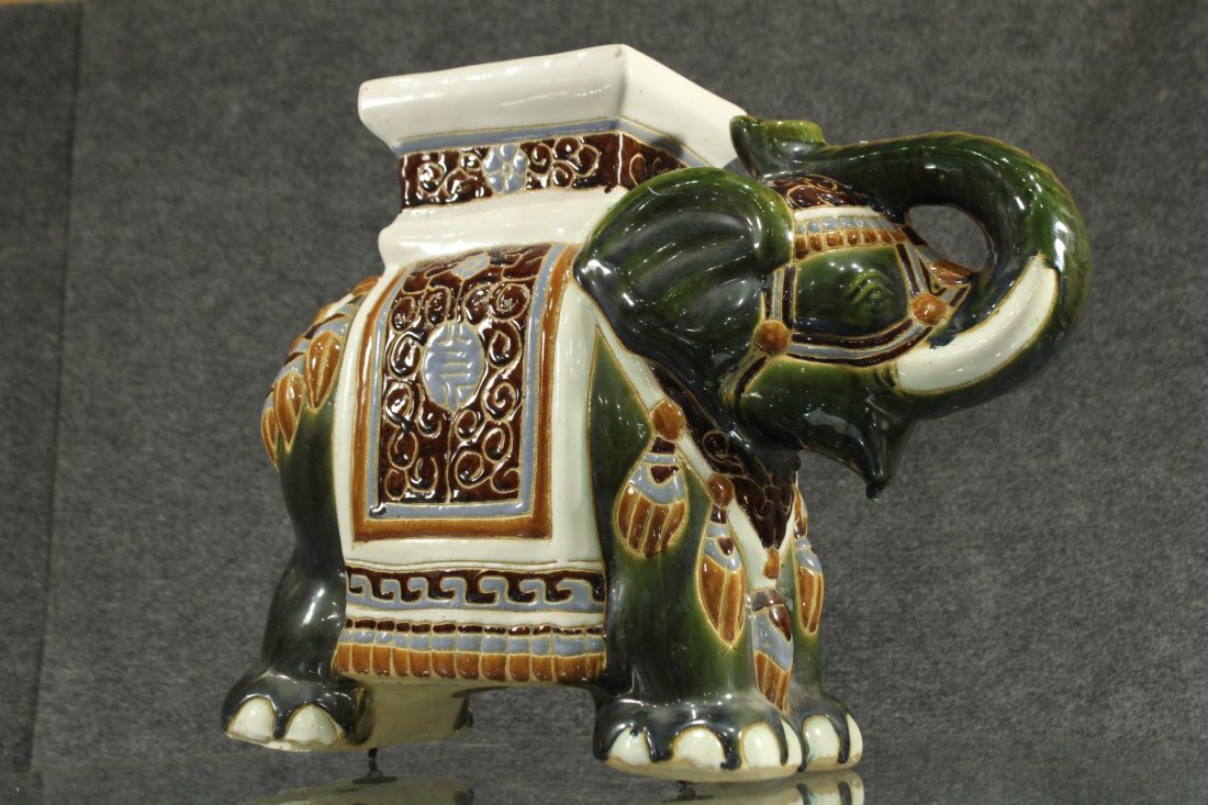 Mid-century modern porcelain elephant: Mid-century modern porcelain elephant , posibly for a plant stand as the harness has a flat table like plateau . elephant has Indian type decorative patterns