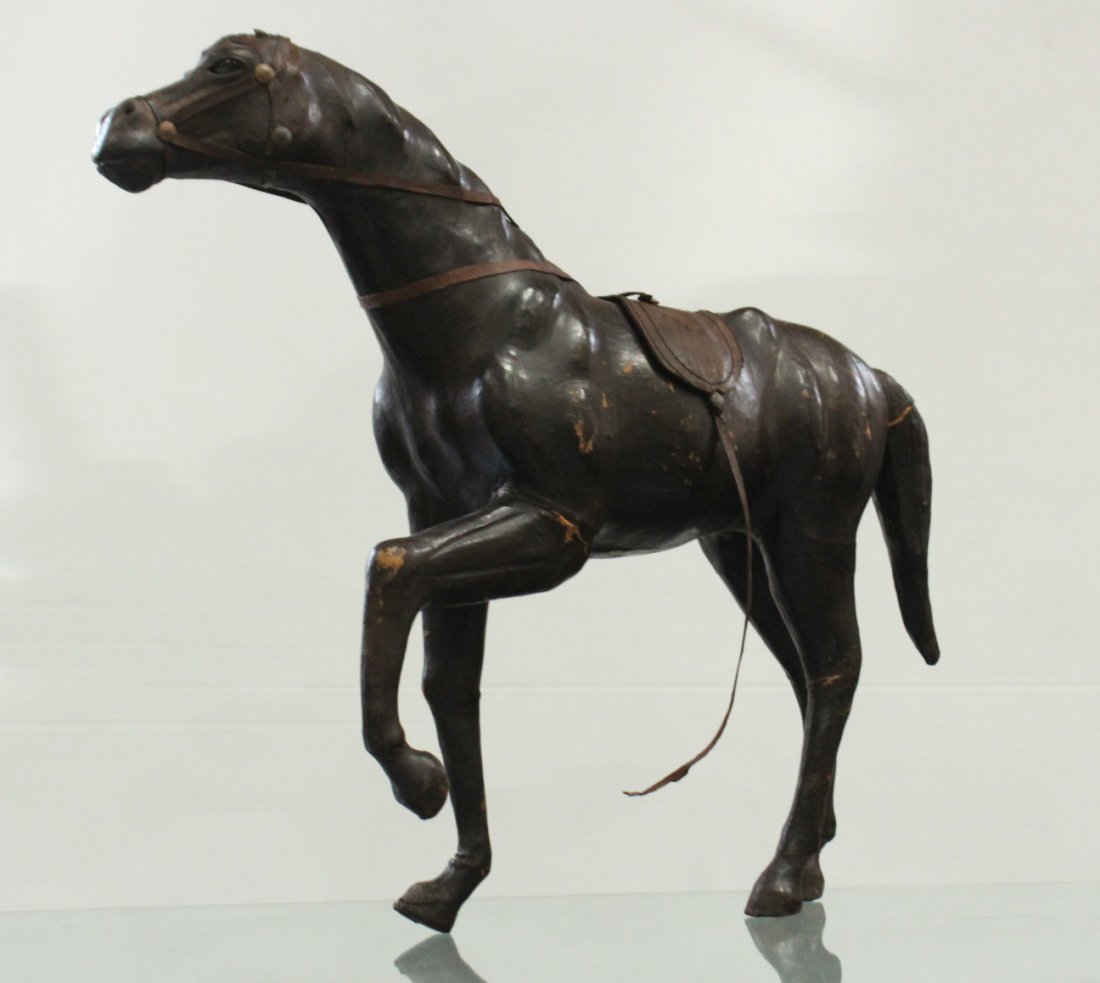 Antique leather horse statue: Antique leather horse statue on 3 legs,