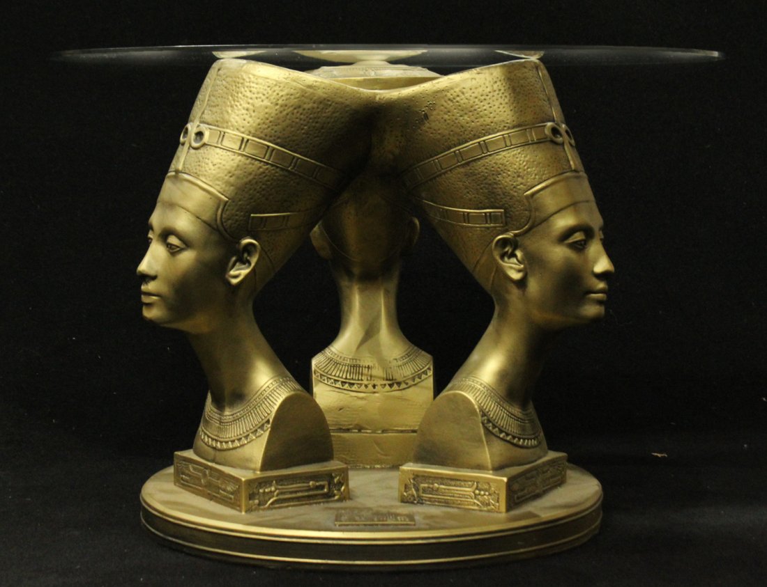Three headed Egyptian influenced glass top table: Three headed Egyptian influenced glass top table. base is a mold with circular glass top Size: 20 h , 28 w