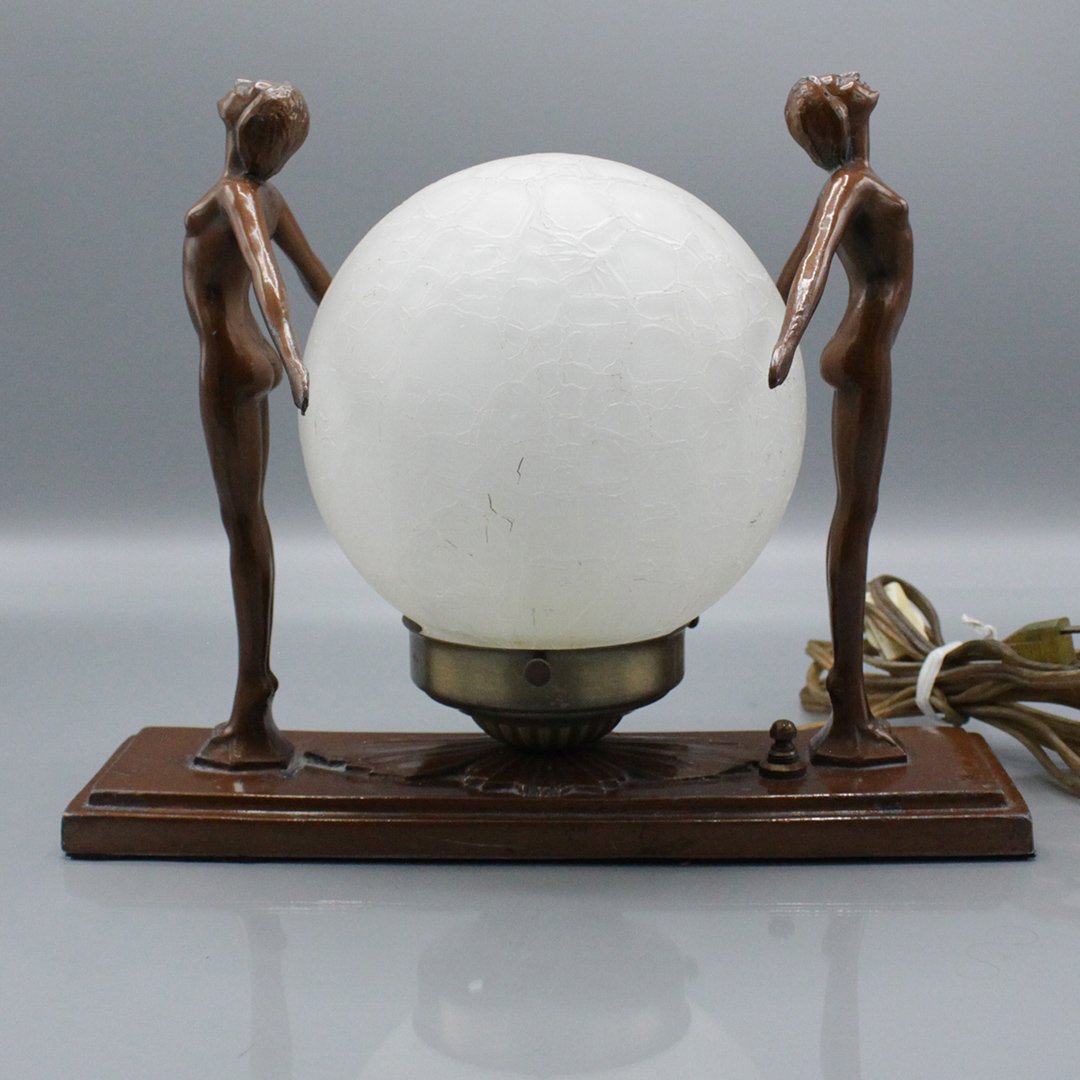 Vintage Art Deco Nude Women Lamp Center Ball Shade: Vintage Art Deco Nude Women Lamp Center Ball Shade. In the manner of Frankart, cast metal lamp with standing nude woman on either side of white glass ball shade. Size: 9 h , 6.5 x 11