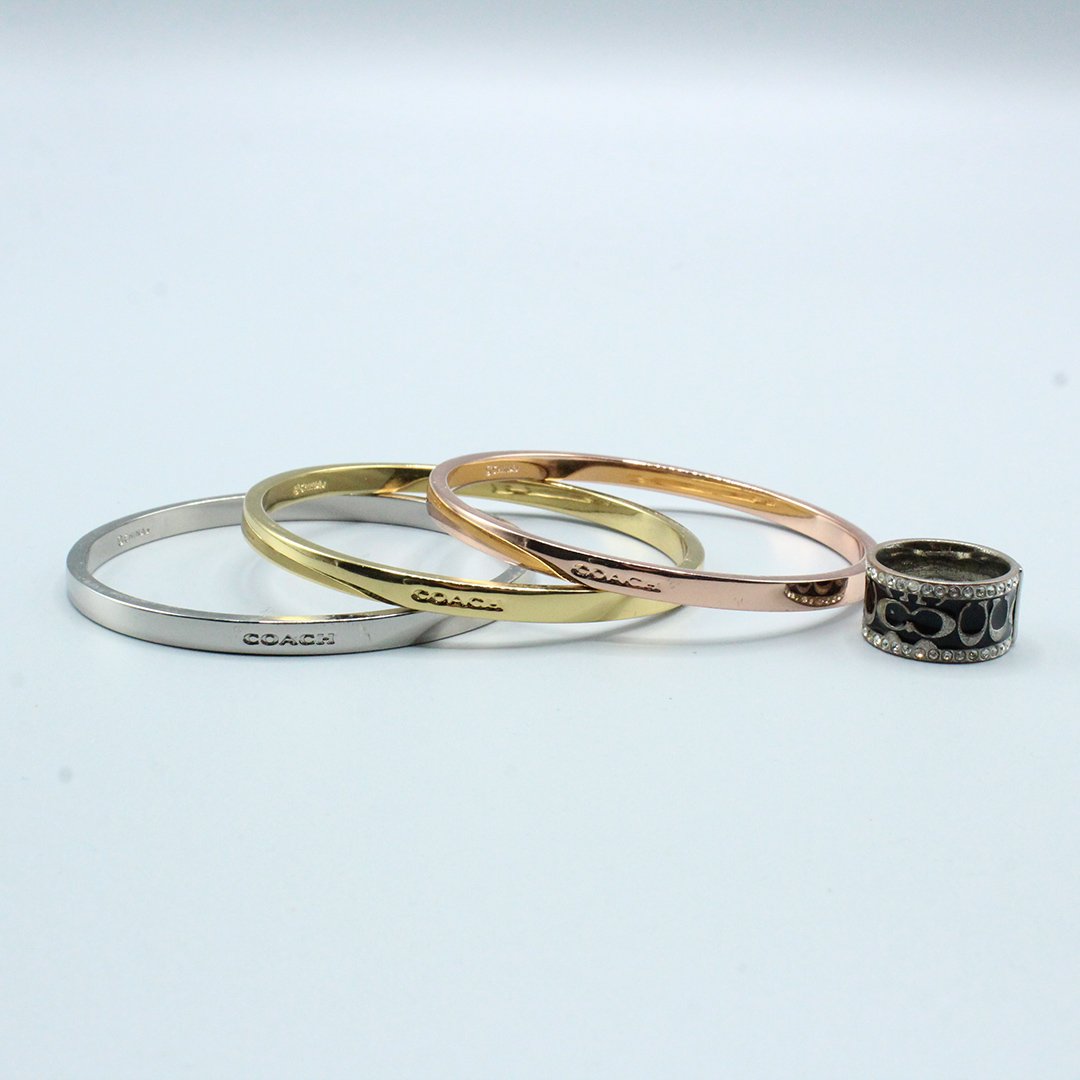 Three COACH Bangle Bracelets, Copper, Silver, Gold Tone: Three COACH Bangle Bracelets in Copper Tone, Silver Tone and Gold Tone. Size: 2.75 in. diameter AND a COACH Ring 7.75